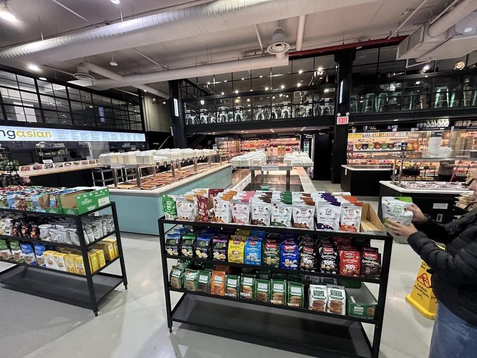 Prepared foods displayed in a bright restaurant interior.